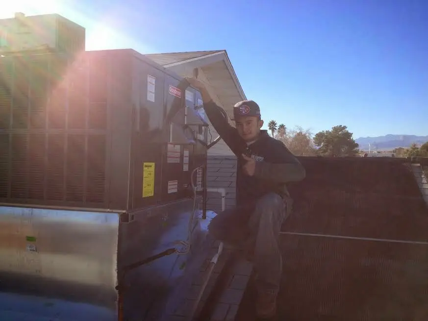 HVAC technician performing Boiler Repair on a rooftop unit in Mount Vernon